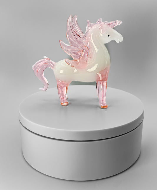 Glass pegasus figurine on a gray background